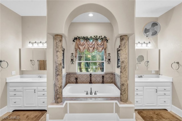 bathroom with a bathing tub and vanity