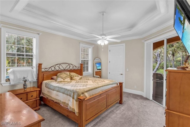 carpeted bedroom featuring ceiling fan, crown molding, and a tray ceiling