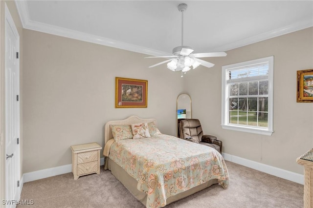 carpeted bedroom featuring ceiling fan and crown molding