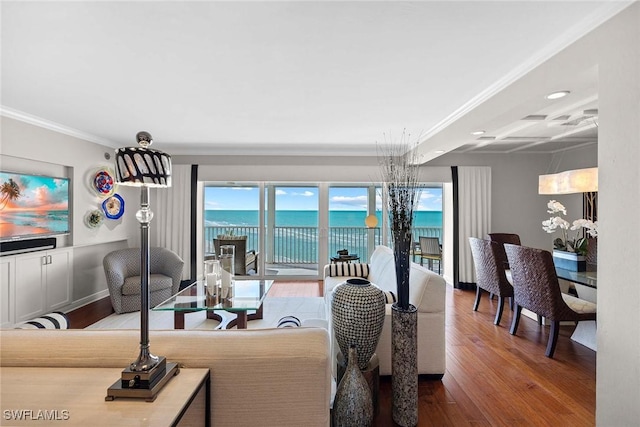 living room featuring a water view, wood-type flooring, coffered ceiling, and ornamental molding