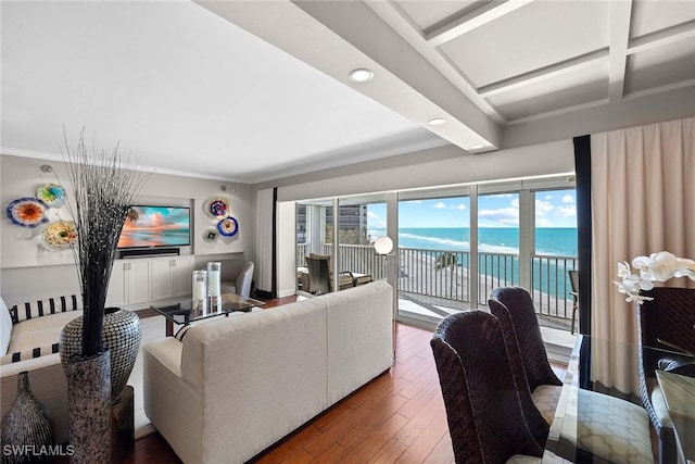 living room featuring hardwood / wood-style floors, beam ceiling, ornamental molding, and coffered ceiling