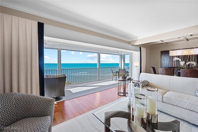 living room featuring hardwood / wood-style floors and a water view