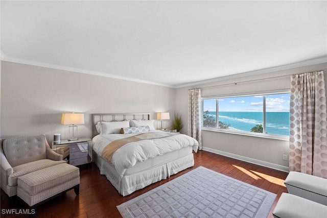 bedroom with a water view, crown molding, and dark wood-type flooring