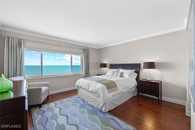 bedroom with dark hardwood / wood-style flooring, a water view, and ornamental molding