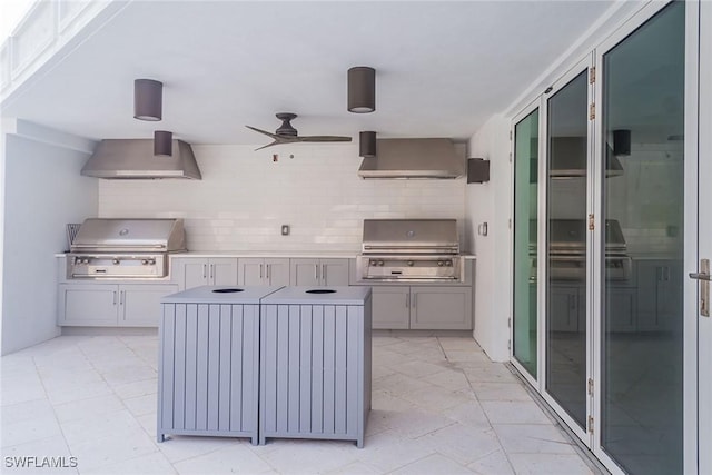 view of patio / terrace featuring a grill, ceiling fan, and exterior kitchen