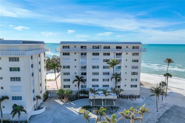 view of property featuring a view of the beach and a water view