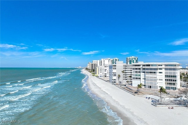 birds eye view of property featuring a water view and a beach view