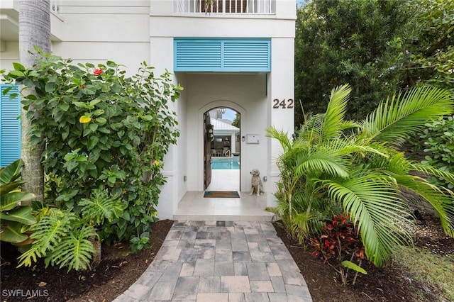 property entrance with stucco siding