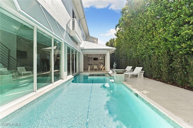 outdoor pool with outdoor dining area and a patio