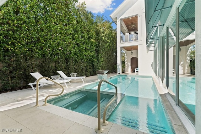 view of swimming pool with a patio area and a pool with connected hot tub