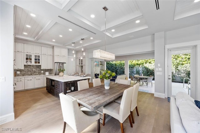 dining room featuring light wood-type flooring, coffered ceiling, beam ceiling, and recessed lighting