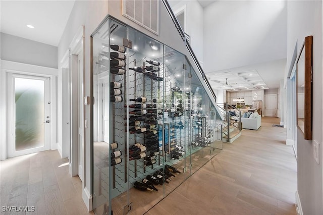 wine cellar featuring recessed lighting, visible vents, and light wood-style flooring