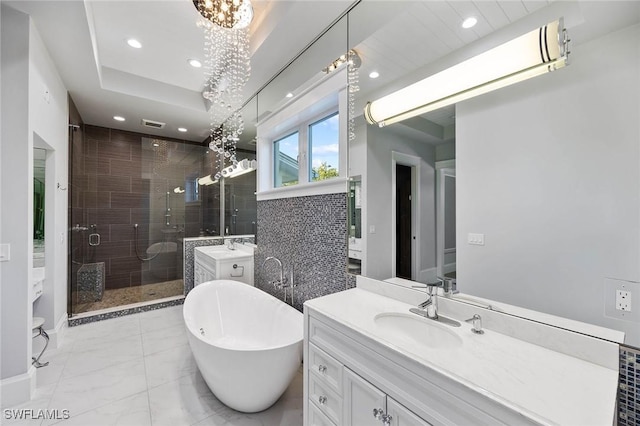 full bathroom featuring recessed lighting, a sink, marble finish floor, a soaking tub, and a stall shower