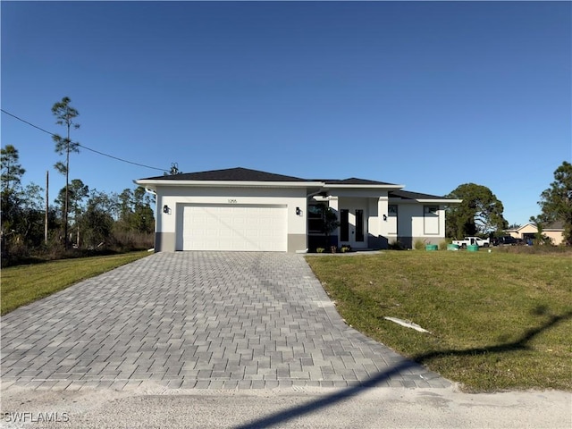 view of front of house with a front yard and a garage