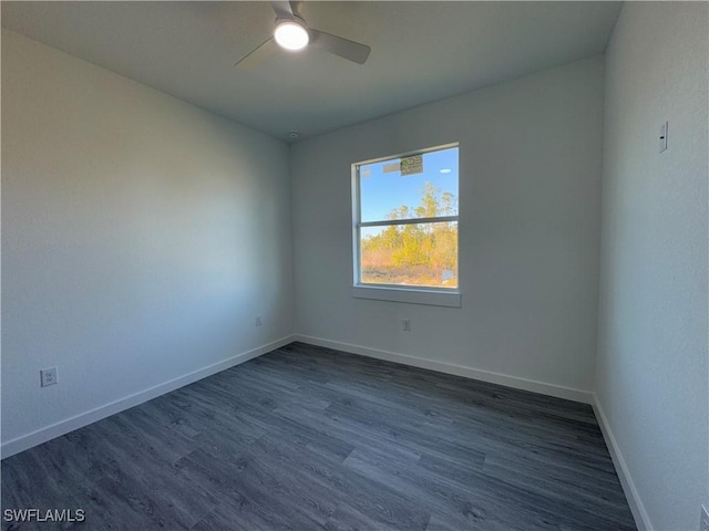 empty room with dark hardwood / wood-style flooring and ceiling fan