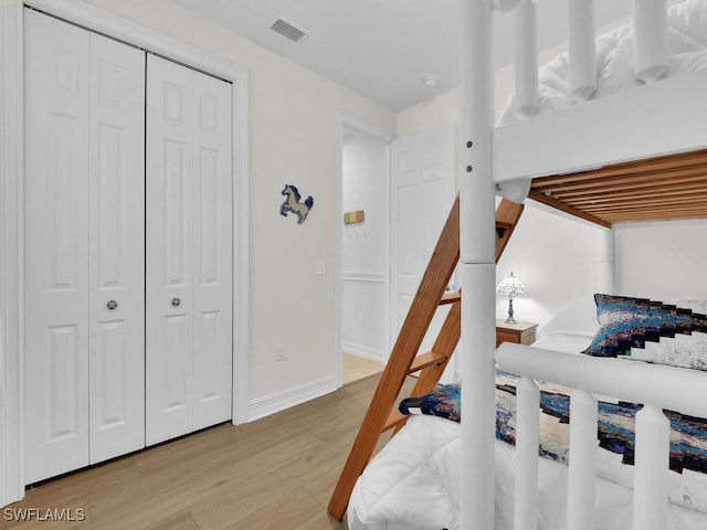 bedroom featuring light hardwood / wood-style flooring and a closet