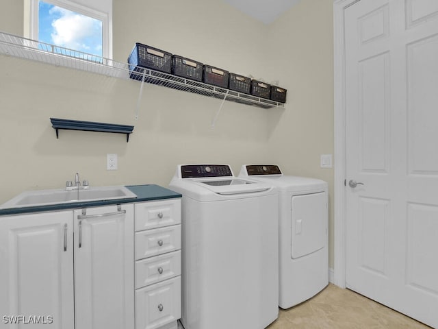 washroom featuring cabinets, independent washer and dryer, sink, and light tile patterned floors