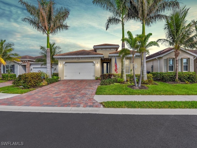 view of front of home featuring a yard and a garage