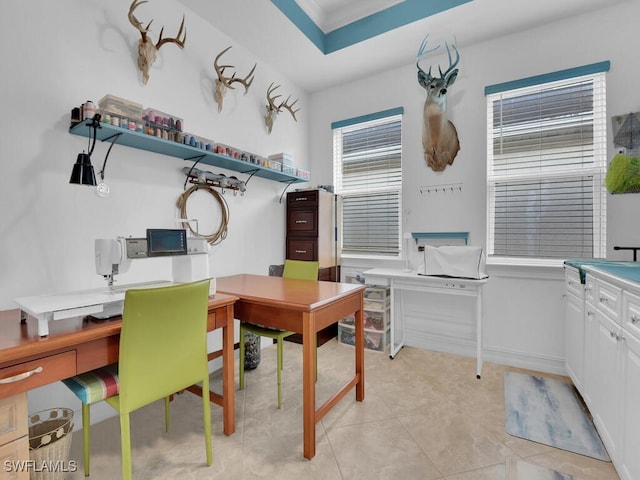 office area with crown molding and light tile patterned floors