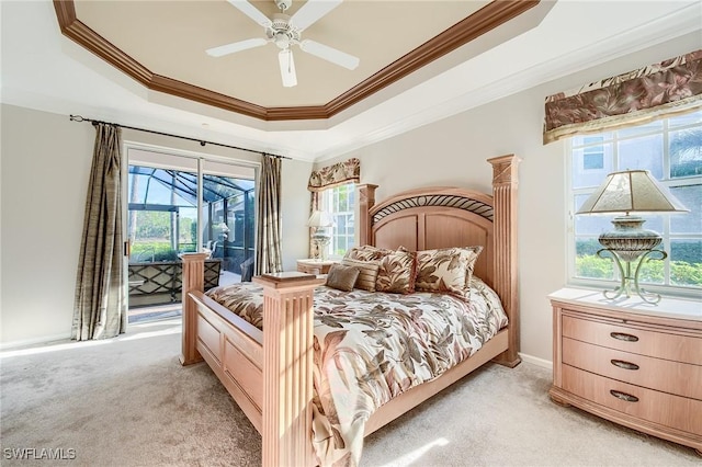 carpeted bedroom with a raised ceiling, ceiling fan, ornamental molding, and access to outside