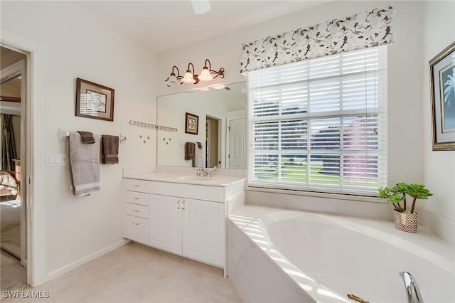 bathroom featuring tile patterned floors, vanity, and tiled bath