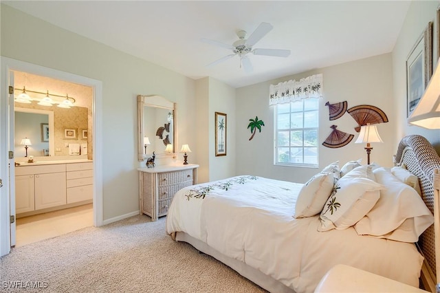 carpeted bedroom with ceiling fan, sink, and ensuite bathroom