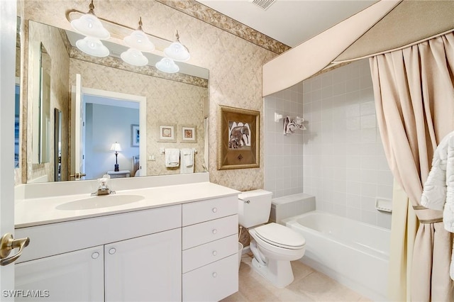 full bathroom featuring tile patterned flooring, vanity, toilet, and shower / bath combo with shower curtain