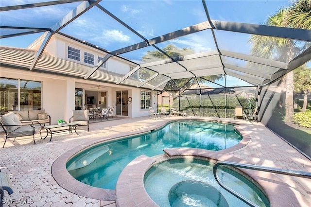 view of swimming pool with outdoor lounge area, an in ground hot tub, a patio, and glass enclosure