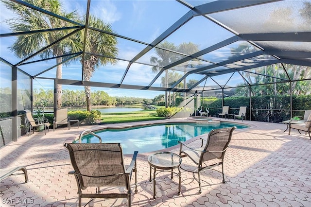 view of swimming pool featuring a lanai, an in ground hot tub, a water view, and a patio