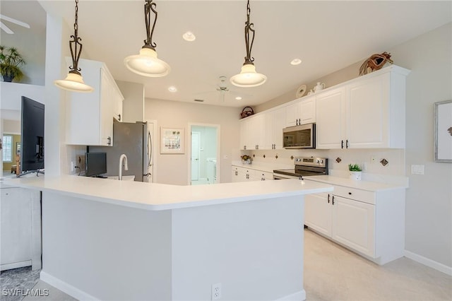 kitchen featuring hanging light fixtures, stainless steel appliances, tasteful backsplash, kitchen peninsula, and white cabinets