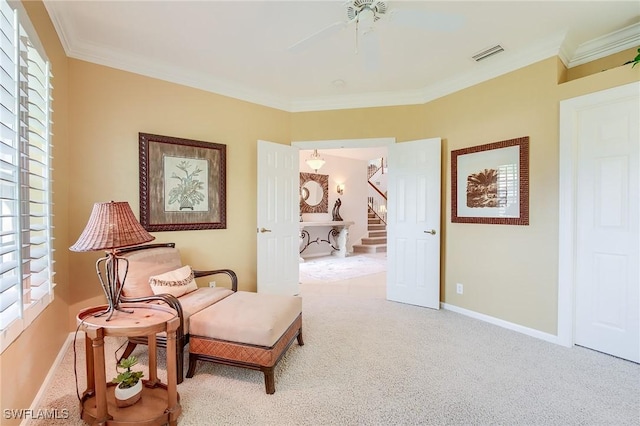 living area featuring ceiling fan, ornamental molding, and light carpet