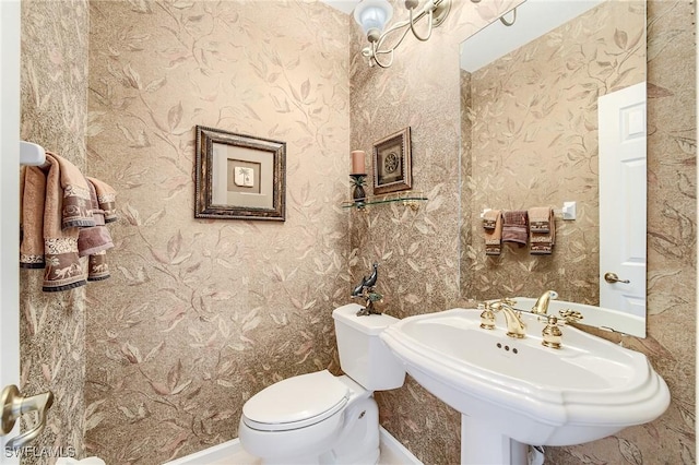 bathroom featuring toilet and sink