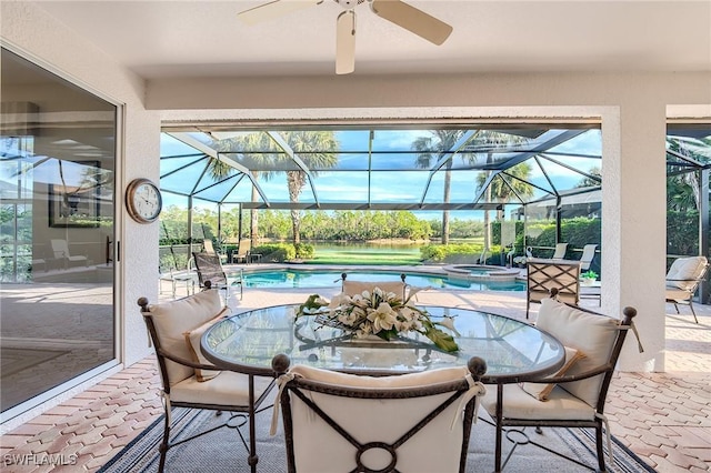 view of patio / terrace with ceiling fan, a lanai, and a pool with hot tub