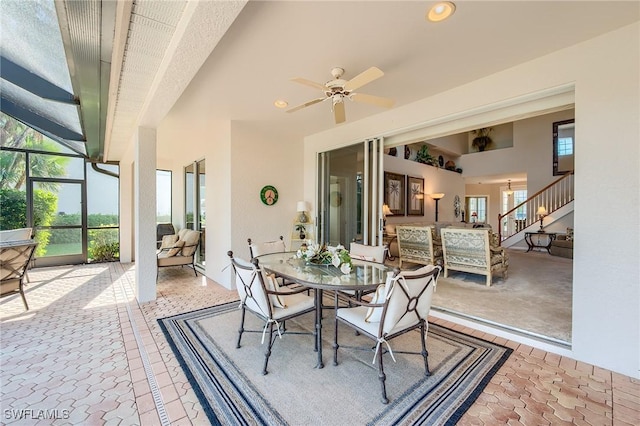 sunroom / solarium featuring ceiling fan