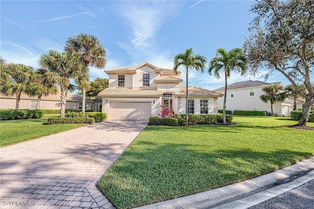 mediterranean / spanish house featuring a garage and a front lawn