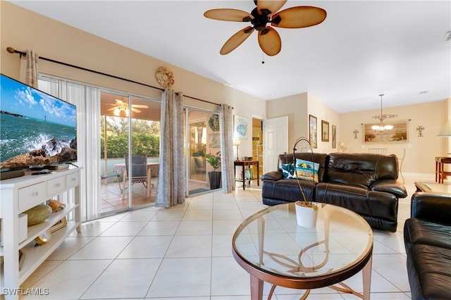 living room with ceiling fan with notable chandelier and light tile patterned floors