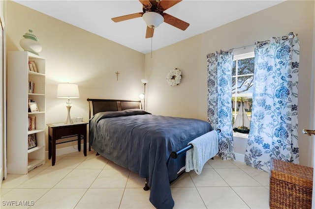 tiled bedroom featuring ceiling fan