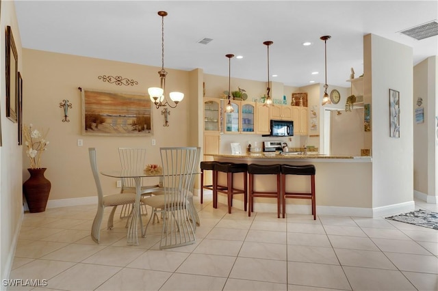 tiled dining area with an inviting chandelier