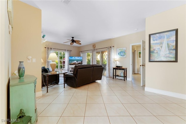 living room featuring light tile patterned floors and ceiling fan