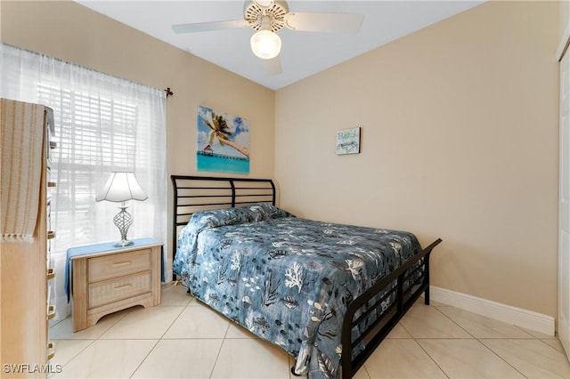 tiled bedroom featuring ceiling fan