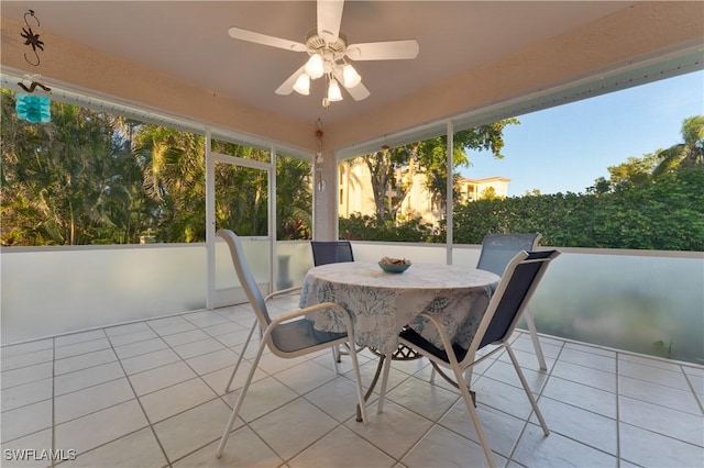 unfurnished sunroom featuring ceiling fan