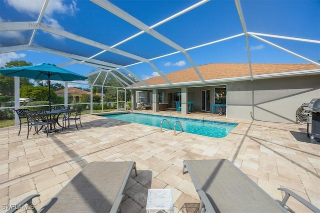 view of pool with a grill, a lanai, and a patio