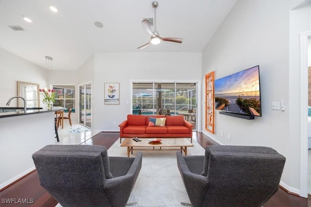 living room with ceiling fan and sink