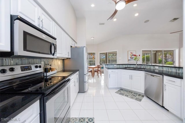 kitchen with ceiling fan, white cabinets, light tile patterned flooring, and appliances with stainless steel finishes