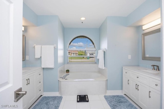 bathroom with tile patterned floors, vanity, and a bath