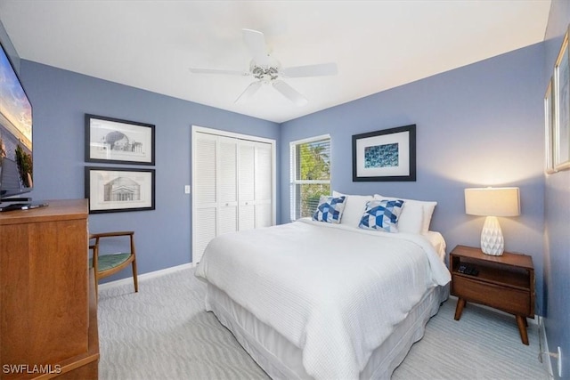 carpeted bedroom with a closet and ceiling fan