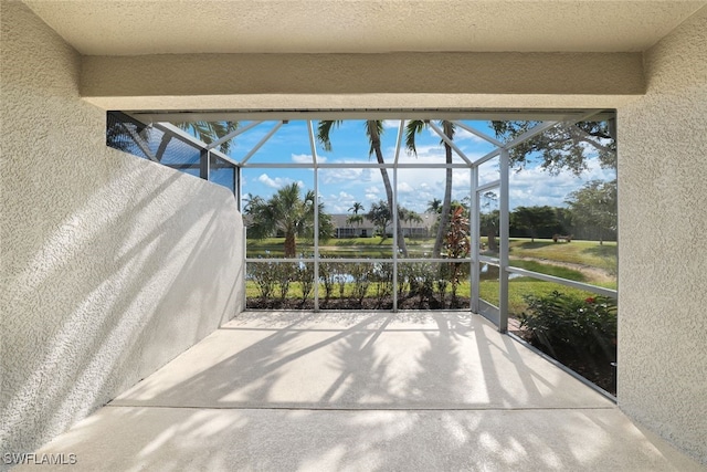 sunroom featuring a water view