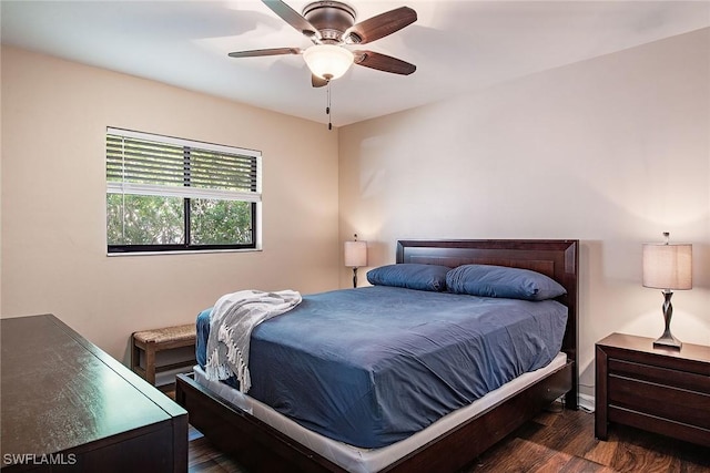 bedroom with ceiling fan and dark hardwood / wood-style floors