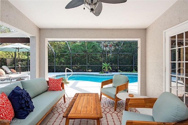 view of swimming pool with an outdoor living space, ceiling fan, a lanai, and a patio