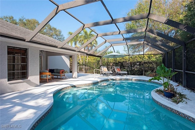 view of swimming pool with a lanai and a patio